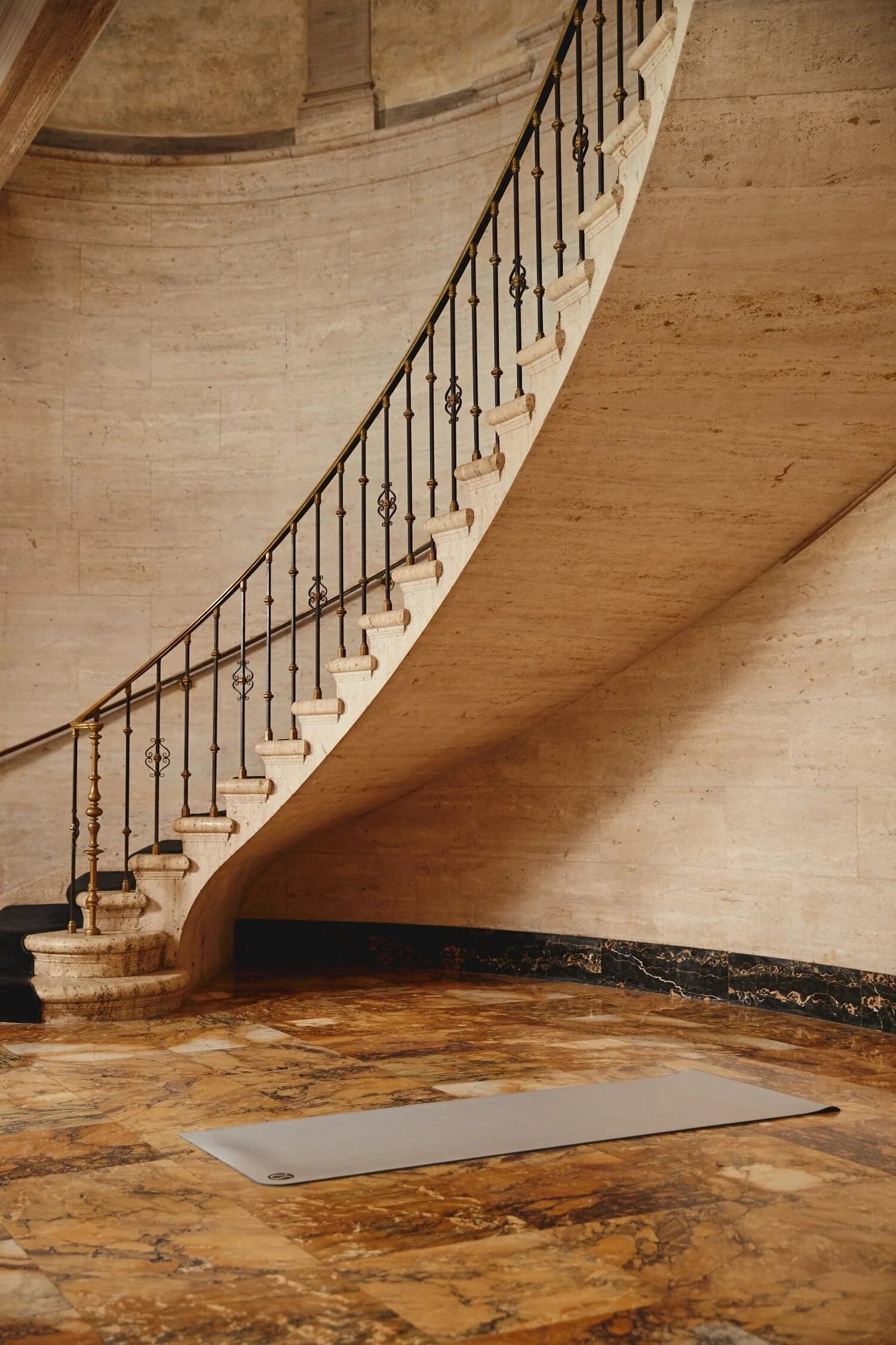 Yoga mat at the foot of a spiral stone staircase