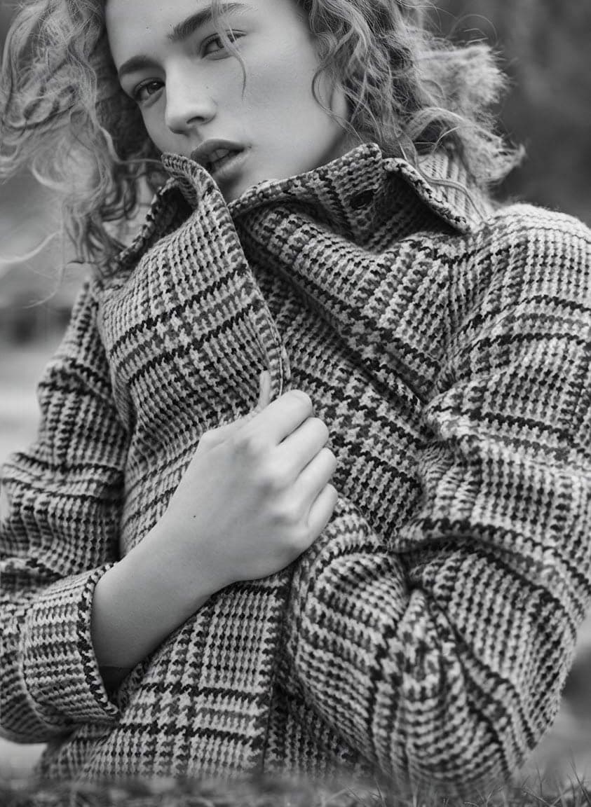 Black-and-white portrait in a houndstooth coat