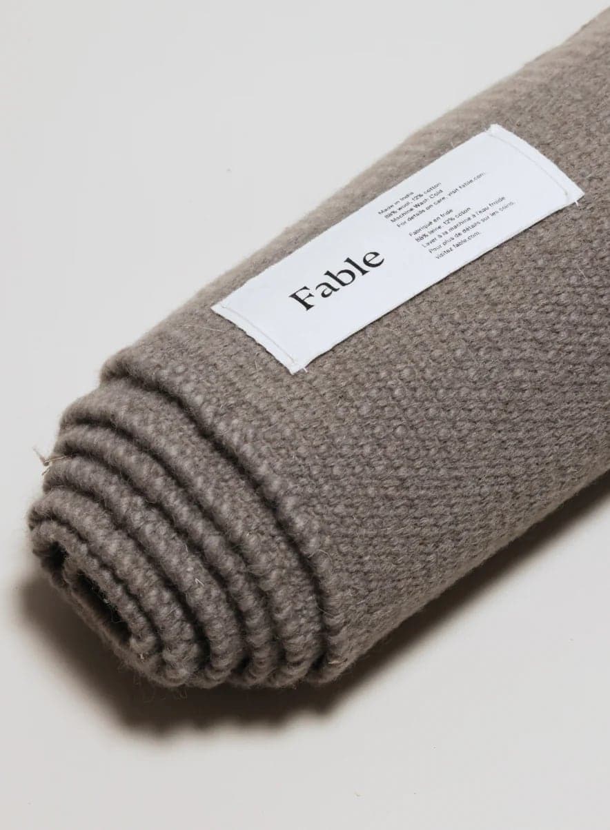 Rolled Fable rug with its label